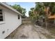 Side yard featuring a grill, palm trees, and partial fencing at 1317 E Laura St, Plant City, FL 33563