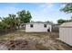 View of the home's back exterior, with a fenced yard and partial view of a storage shed at 1317 E Laura St, Plant City, FL 33563