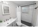 Bathroom features a walk-in shower, gray vanity, modern mirror, and sleek fixtures throughout at 1317 E Laura St, Plant City, FL 33563
