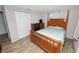 This bedroom offers warm wood floors and a four-poster bed frame. The room feels cozy and inviting at 1317 E Laura St, Plant City, FL 33563