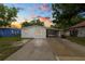 Front exterior of the home at sunset, with a paved driveway and covered carport at 1317 E Laura St, Plant City, FL 33563