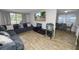 Cozy living room with hardwood floors, a sectional sofa, and a large screen TV at 1317 E Laura St, Plant City, FL 33563