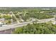 Aerial view of a quiet neighborhood with lush greenery, well-maintained homes and mature trees at 1603 N Park Rd, Plant City, FL 33563