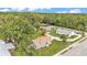 Charming grey home with well-maintained yard, nestled in a lush, green neighborhood with mature trees at 1603 N Park Rd, Plant City, FL 33563