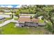 Grey home featuring a well-maintained yard, new white fence and a cozy back patio at 1603 N Park Rd, Plant City, FL 33563