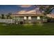 Back exterior of grey home with a well-maintained yard and a new white fence at 1603 N Park Rd, Plant City, FL 33563