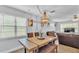 Cozy dining area features a rustic wood table and a unique chandelier, perfect for intimate gatherings at 1603 N Park Rd, Plant City, FL 33563