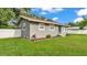 This exterior view highlights the neatly landscaped lawn, white fenced yard, and the home's architecture at 1603 N Park Rd, Plant City, FL 33563