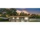 Charming grey home featuring a manicured lawn, inviting entryway and mature trees at 1603 N Park Rd, Plant City, FL 33563