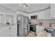 Modern kitchen features stainless steel appliances, marble countertops, and stylish backsplash at 1603 N Park Rd, Plant City, FL 33563