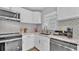 Bright kitchen boasts stainless steel appliances, marble countertops, and custom backsplash design at 1603 N Park Rd, Plant City, FL 33563