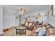 Open-concept living room with modern furnishings, a ceiling fan, and views into the dining area at 1603 N Park Rd, Plant City, FL 33563