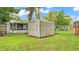 A storage shed in a fenced backyard, with plenty of space for outdoor activities and storage at 1603 N Park Rd, Plant City, FL 33563