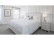Inviting bedroom featuring a comfortable bed, accent wall, and plenty of natural light at 2750 Walden Town Cir, Plant City, FL 33566