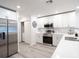 Modern kitchen with stainless steel appliances, quartz countertops, and bright white cabinets at 2750 Walden Town Cir, Plant City, FL 33566
