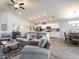 Inviting living area with open layout, modern furnishings, seamlessly connecting the living room, kitchen, and dining space at 35444 Darlington Grove Dr, Zephyrhills, FL 33541
