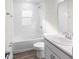 Clean, bright bathroom with white fixtures, shower-tub combination and modern sink and vanity at 35452 Darlington Grove Dr, Zephyrhills, FL 33541