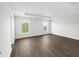 Spacious, bright bedroom featuring luxury vinyl plank flooring, tray ceiling, and natural light at 35452 Darlington Grove Dr, Zephyrhills, FL 33541