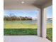 Lake view from the covered patio overlooking lush green grass and scenic lake at 35452 Darlington Grove Dr, Zephyrhills, FL 33541