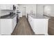 Well-equipped kitchen with stainless steel appliances, granite countertops, and island with sink at 35452 Darlington Grove Dr, Zephyrhills, FL 33541