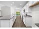 Bright kitchen features white cabinets, granite countertops, stainless steel appliances, and lake view at 35452 Darlington Grove Dr, Zephyrhills, FL 33541