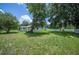 Expansive grassy backyard perfect for outdoor activities, with mature trees and a peaceful setting at 3611 Maxwell Rd, Plant City, FL 33566