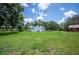 Expansive backyard featuring lush greenery and a charming white home, perfect for outdoor activities at 3611 Maxwell Rd, Plant City, FL 33566