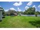 Large grassy backyard with a trampoline and privacy fence, ideal for recreation and relaxation at 3611 Maxwell Rd, Plant City, FL 33566