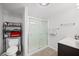 Bright bathroom featuring a glass-enclosed shower, vanity, and convenient shelving at 3611 Maxwell Rd, Plant City, FL 33566