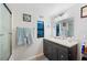 Bright bathroom vanity and shower tub combo, adorned with decorative art and towel rack near sink at 3611 Maxwell Rd, Plant City, FL 33566