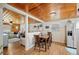 Cozy dining room featuring a wooden table and chairs, with a view into the living room with wood ceilings at 3611 Maxwell Rd, Plant City, FL 33566