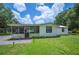 Charming single-story home with a well-maintained lawn, screened porch, and inviting curb appeal at 3611 Maxwell Rd, Plant City, FL 33566