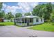 Charming single-story home with a screened-in porch and well-maintained landscaping at 3611 Maxwell Rd, Plant City, FL 33566