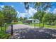 Scenic property featuring a gated driveway, lush greenery, and a cozy home perfect for outdoor enjoyment at 3611 Maxwell Rd, Plant City, FL 33566