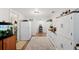 Hallway features storage cabinets, hardwood floors and rug at 3611 Maxwell Rd, Plant City, FL 33566