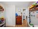 Hallway featuring wood-look floors and access to another room, with shelf and a wooden dresser at 3611 Maxwell Rd, Plant City, FL 33566