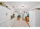 Hallway featuring storage cabinets, hardwood floors, and an adjacent dining room at 3611 Maxwell Rd, Plant City, FL 33566