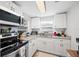 Bright kitchen with white cabinets, granite countertops, and modern appliances for a seamless cooking experience at 3611 Maxwell Rd, Plant City, FL 33566