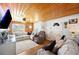 Cozy living room featuring wood plank ceiling, comfortable seating, and a bright, welcoming atmosphere at 3611 Maxwell Rd, Plant City, FL 33566
