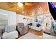 Comfortable living room with wooden ceiling, neutral furniture, and open layout to other rooms in home at 3611 Maxwell Rd, Plant City, FL 33566
