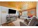 Inviting living room with wood plank ceiling, stylish decor, and ample natural light creating a cozy ambiance at 3611 Maxwell Rd, Plant City, FL 33566