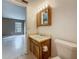 Bathroom view showing toilet, wood vanity with sink and mirror, and tile flooring at 4022 Tumble Wood Trl # 101, Tampa, FL 33613