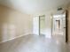 View of a neutral bedroom with tile flooring and closet with sliding doors at 4022 Tumble Wood Trl # 101, Tampa, FL 33613