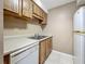 Kitchen featuring stainless steel sink, wooden cabinets and laminate countertop at 4022 Tumble Wood Trl # 101, Tampa, FL 33613