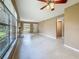 Bright living room featuring tile floors, a fireplace, a ceiling fan, and large windows at 4022 Tumble Wood Trl # 101, Tampa, FL 33613