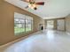 Bright living room featuring tile floors, a fireplace, a ceiling fan, and large windows at 4022 Tumble Wood Trl # 101, Tampa, FL 33613