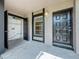 Enclosed patio with in unit washer and dryer hookup, neutral paint, and a black front door at 4022 Tumble Wood Trl # 101, Tampa, FL 33613