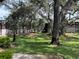 Scenic view of the community lawn with lush green grass and mature oak trees on a sunny day at 4022 Tumble Wood Trl # 101, Tampa, FL 33613