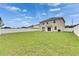 Spacious backyard with a well-maintained lawn and white fence, perfect for outdoor activities at 503 Arbequina Ct, Plant City, FL 33566