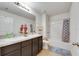 Well-lit bathroom featuring double sinks, a vanity, and a shower-tub combination at 503 Arbequina Ct, Plant City, FL 33566